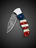 Ripple pattern Damascus steel blade extended on American flag folding knife