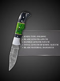 Handmade Damascus steel blade pattern detail on black and green folding knife