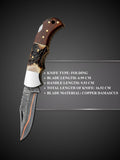 Polished copper Damascus steel blade pattern detail on brown folding knife