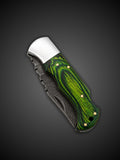 Close up of green Pakkawood grip with polished bolsters and brass pins