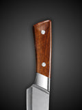 Close up of triple riveted wooden handle on Damascus kitchen chef knife